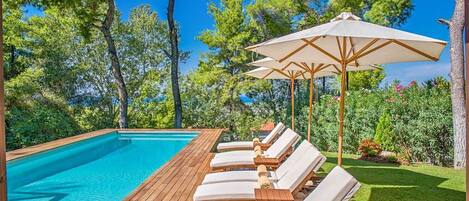 A heated pool, pool loungers
