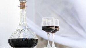 A wine bottle and two glasses on a stone ledge. - Chapel View - One Bedroom Villa, Sleeps 2 (Ionian Islands)