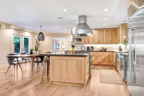 A modern kitchen with wooden cabinets, stainless steel appliances, and a central island. - Sonoma Country Club Wine Country w/ pool (Sonoma)