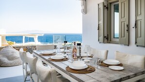 A dining area with a table set for four, overlooking a scenic view.