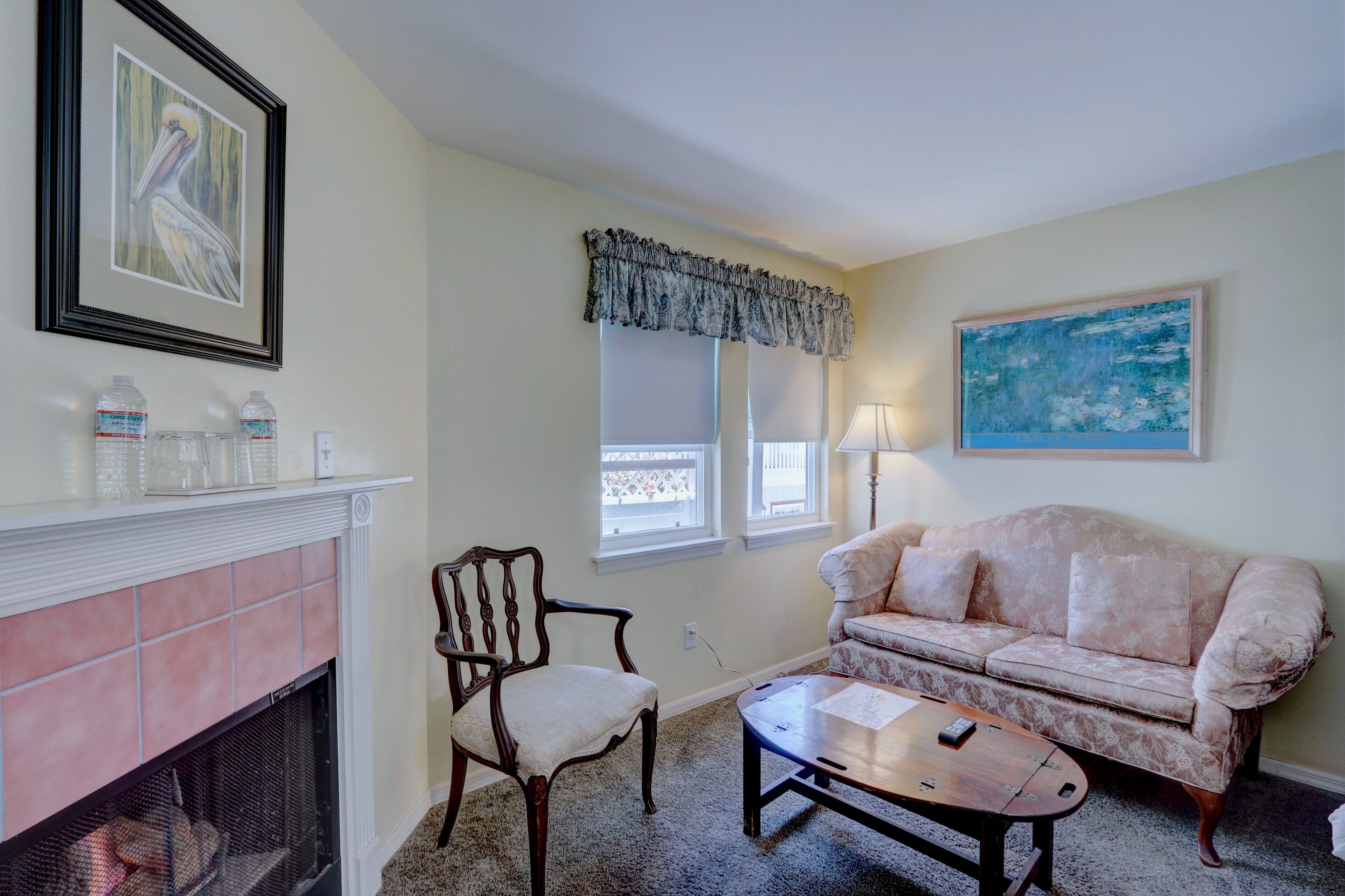 A living room with a fireplace, a sofa, a chair, and a coffee table.