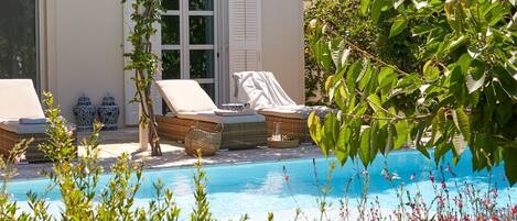 A heated pool, sun loungers