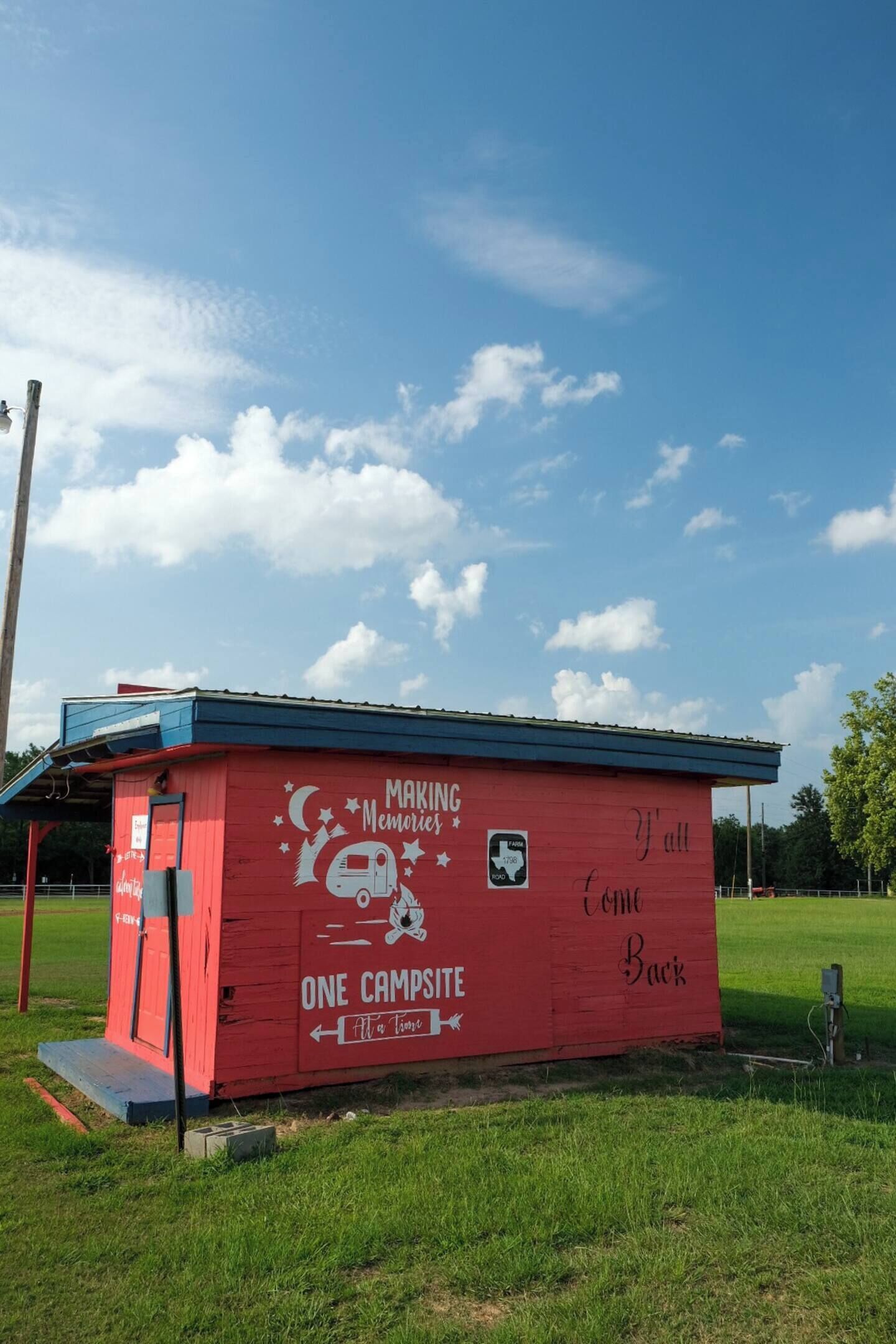 A red building with a blue roof, labeled "Making Memories" and "One Campsite."