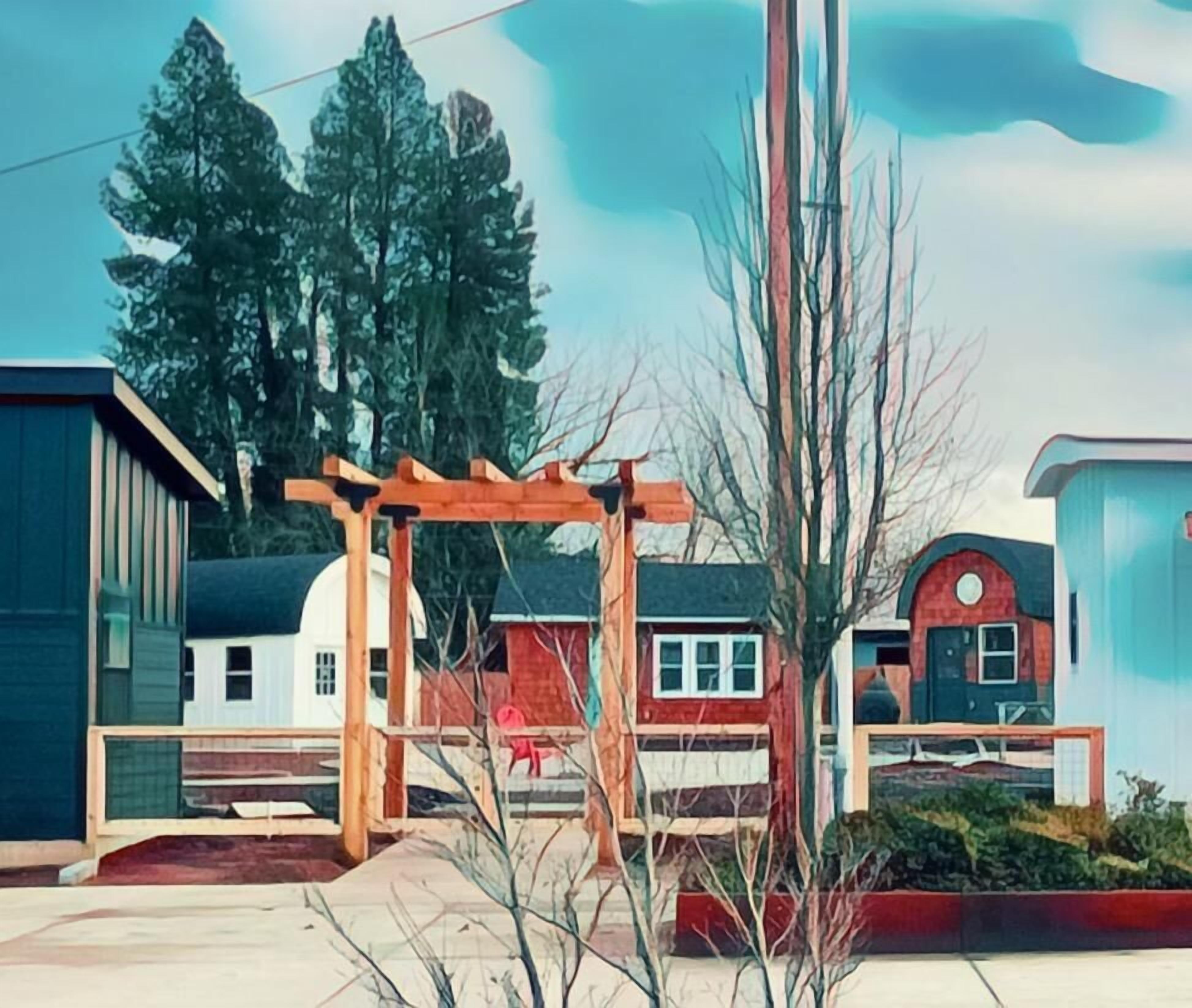 A residential area with a wooden pergola, a red house, and a blue building.