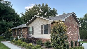 A single-story house with a brick facade, a sloped roof, and a front porch. - Home away from home 37043 (Clarksville)