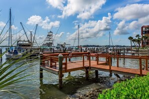 A marina with wooden docks, boats, and a clear sky.