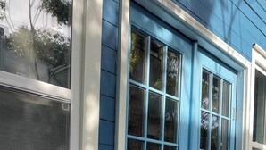 A blue house with a front door, a window, and a doormat with the word "hello". - Walking distance to St George, packed with attractions and activities! (St. Augustine)