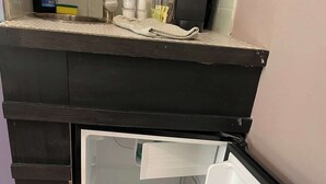 A kitchen with a black countertop, a stainless steel sink, and a white refrigerator with its door open. - Walking distance to St George, packed with attractions and activities! (St. Augustine)