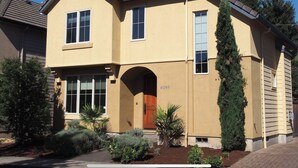 A two-story house with a beige exterior, a brown roof, and a number '4089' on the front.