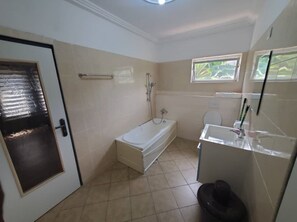 Combined shower/tub, towels, soap, toilet paper - Affordable & Sweet One Bedroom Apartment with Living Room & Bathtub (Greater Accra Region)