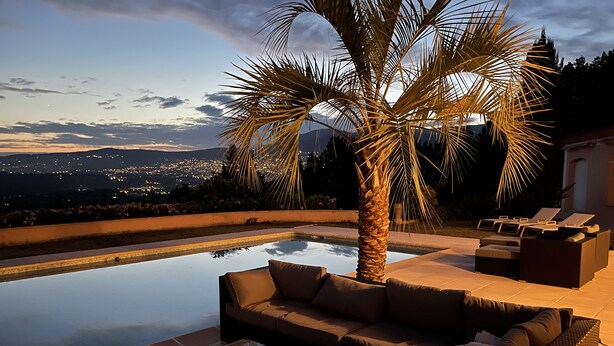 A poolside area with a sofa, lounge chairs, and a palm tree. - Charming 6-bedroom villa (Mouans-Sartoux)
