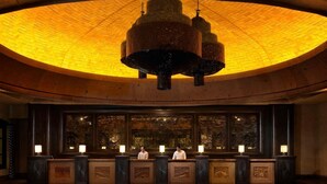 A lobby with a circular ceiling and a reception desk area.