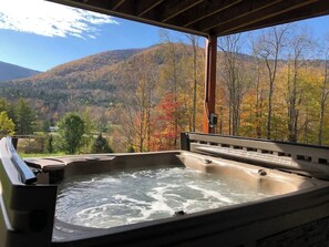 A hot tub with a view of a forested mountain range. - Hunter Mountain Luxury Cabin | Hot Tub | Fire Pit (Hunter)