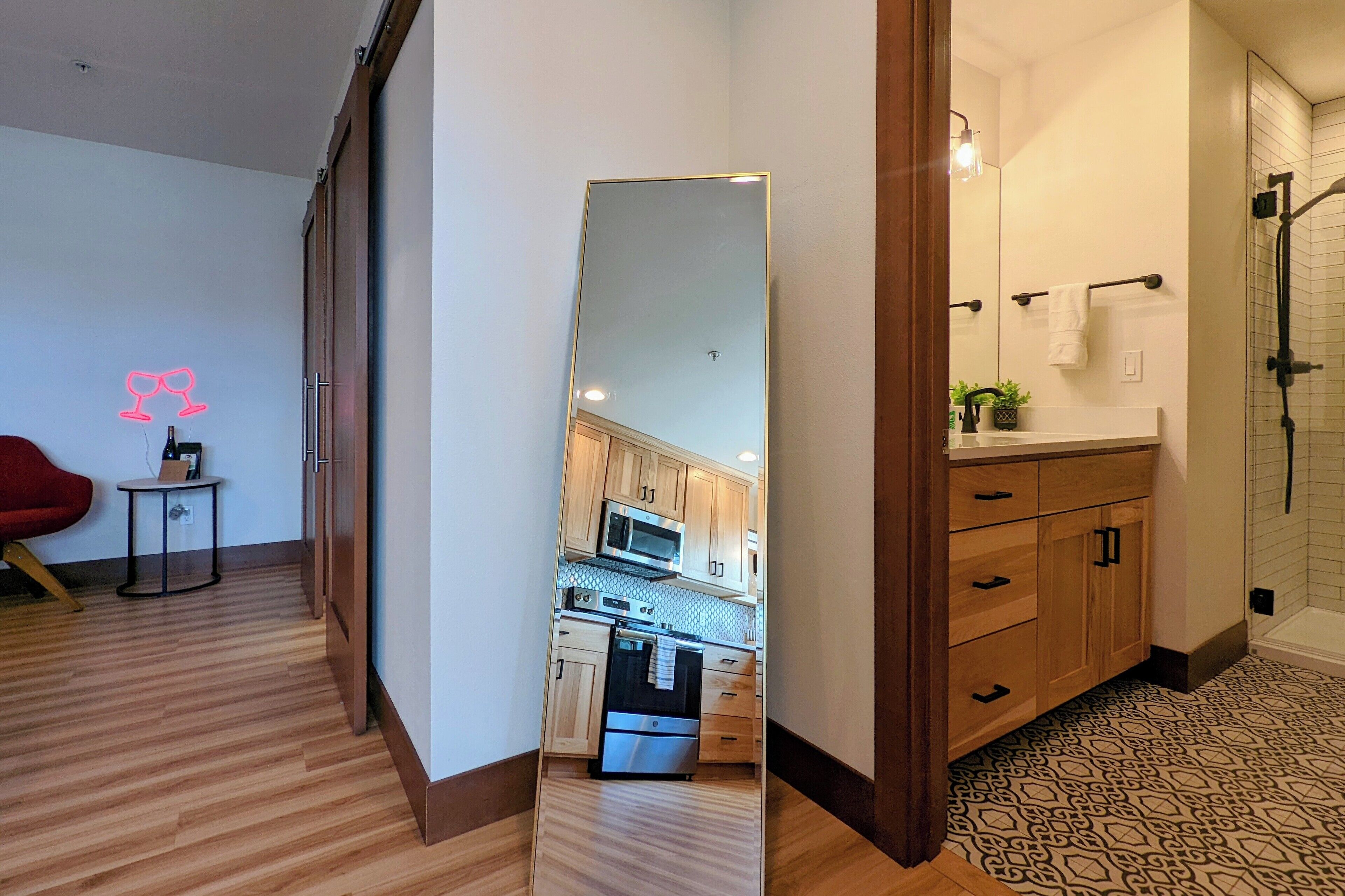 Eine moderne Küche mit Holzausstattung, einer eingebauten Mikrowelle und einem Edelstahlbackofen.