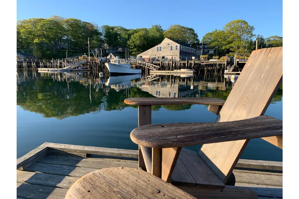 Vintage cabin perched on edge of harbor with dock