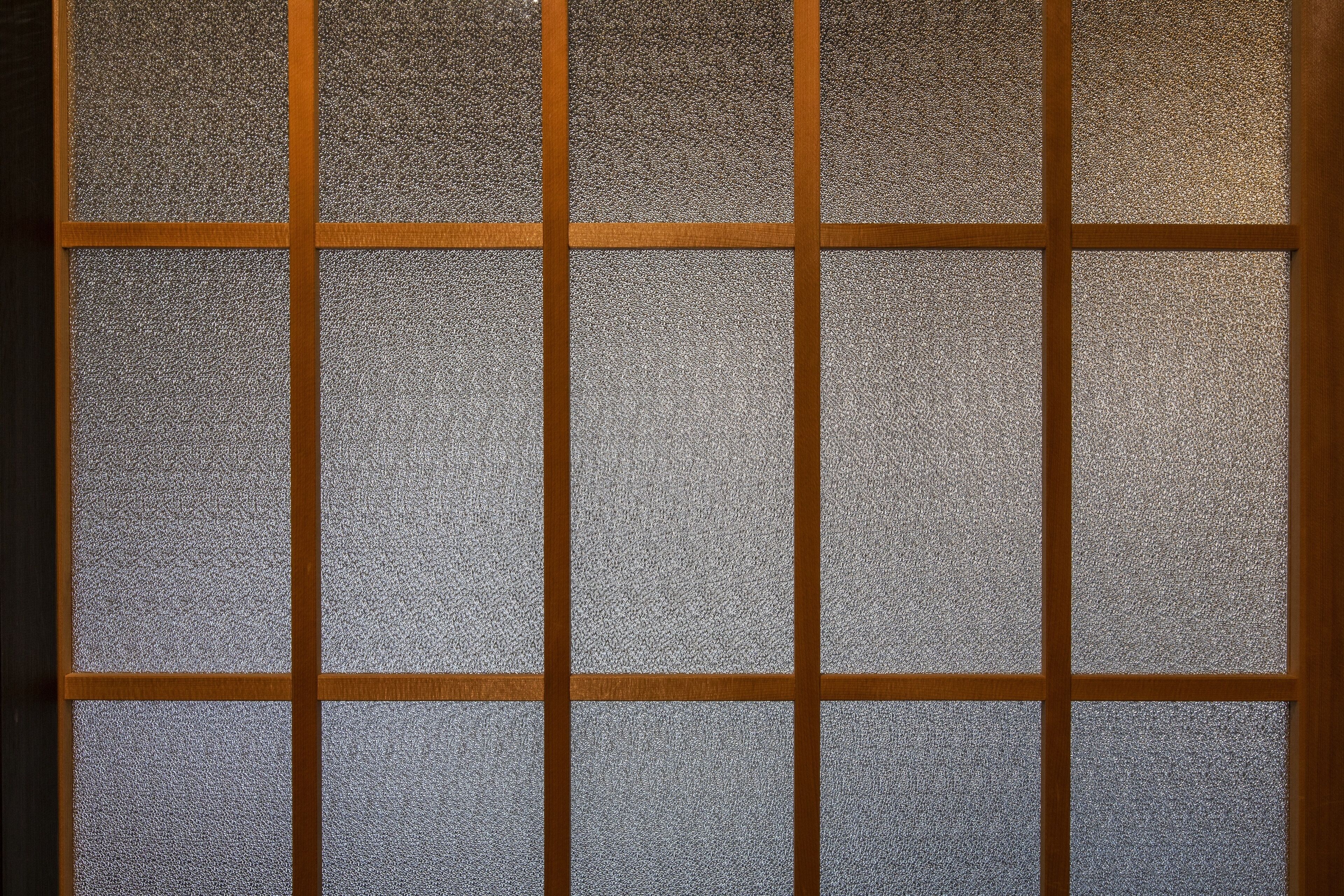 A grid of frosted glass panels with wooden frames.