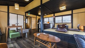 A traditional Japanese-style room with tatami flooring, low wooden tables, and cushions. - Tofukuji SAKURA (Kyoto)