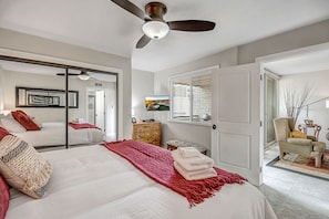 Cozy retreat with a large bed, TV, and dresser, perfect for a comfortable stay.