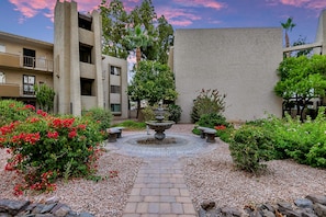 Stroll through the tranquil courtyard, surrounded by lush greenery and vibrant flowers, and enjoy the soothing sounds of the central fountain.