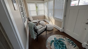 Une pièce confortable avec un lit, une chaise, une petite table et un tapis décoratif.