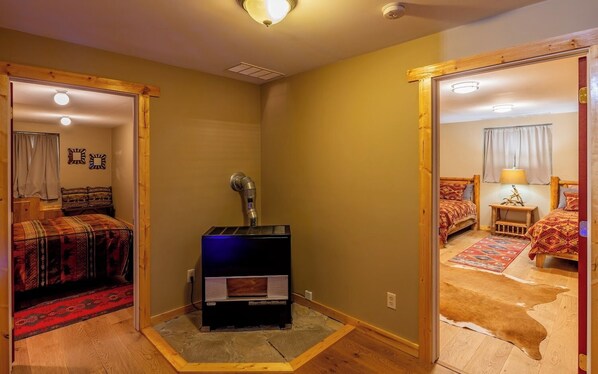 A room with a bed, a heater, and a mirror.