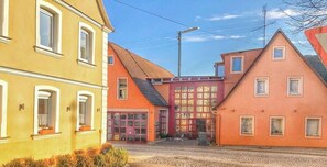 Une vue de rue avec des bâtiments, une route pavée et un ciel dégagé.