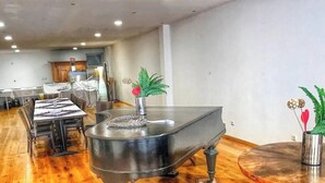 A spacious kitchen with a dining area, wooden flooring, and modern appliances.