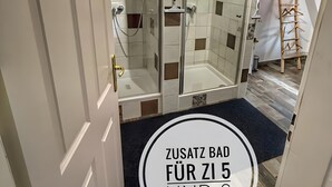 Ein Badezimmer mit Duschkabine, Badewanne und Toilette.