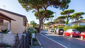 A residential street with parked cars, a sidewalk, and trees. - Apartment 'Perla Marina' with Garden & Terrace (grosseto)