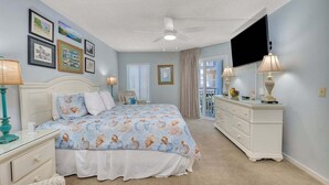A bedroom with a bed, dresser, and television. - Oceanfront Condominium with Amenities (Saint Simons Island)