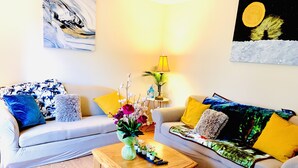 A living room with two sofas, a coffee table, and a lamp.