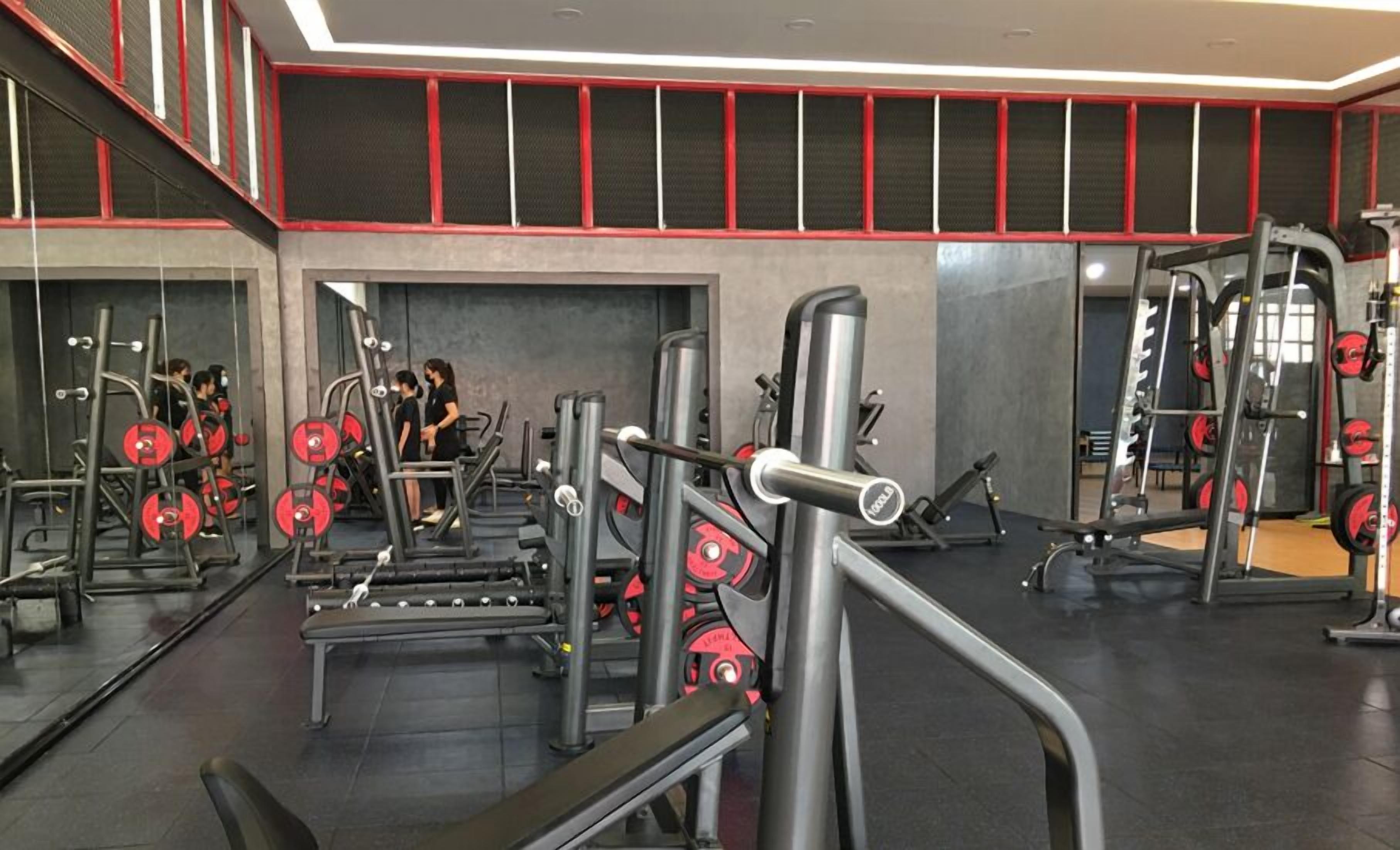 A gym with various exercise equipment, including weight machines and treadmills.