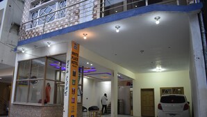 A hotel entrance with a sign reading "White Place Hotel Naran."