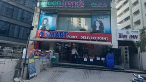 A multi-story building with signage for 'Siri Inn Luxury Rooms' and 'Green Trends Unisex Hair & Style Salon'. - Hotel Siri Inn (Hyderabad)