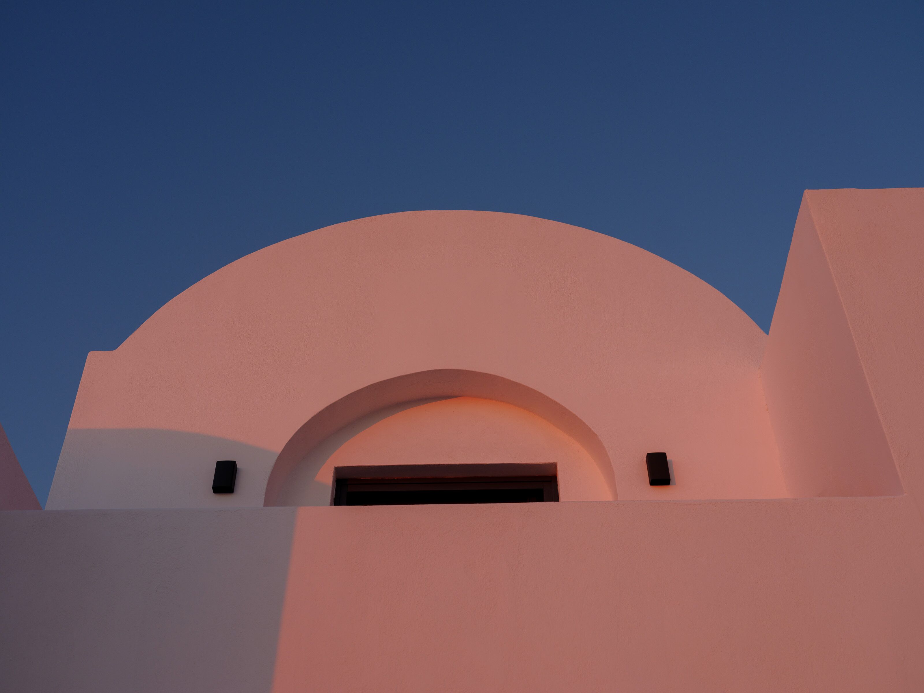 A building with a large, rounded archway and a flat roof.