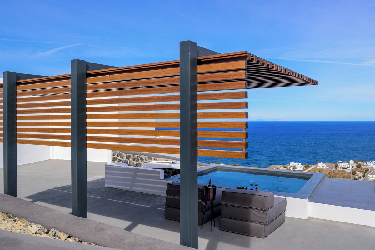 A modern outdoor seating area with a pool, wooden slats, and a view of the sea.