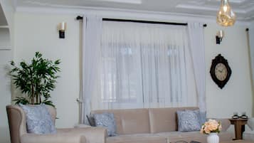 Deluxe Villa | Living area | 32-inch flat-screen TV with digital channels