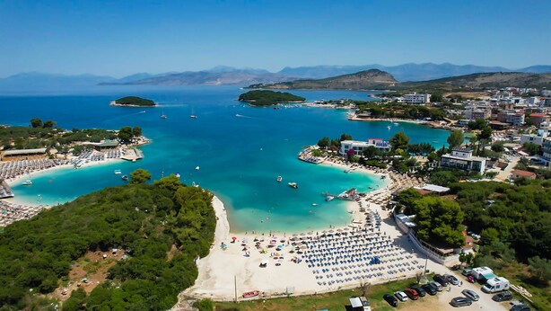 A coastal town with a beach, boats, and a marina. - Siars Hotel (Ksamil)