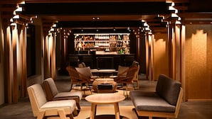 A bar area with wooden furniture and a well-lit interior.