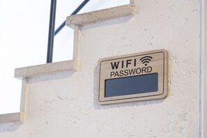 A sign on a wall indicating a WIFI password. - [Trastevere] A cozy and charming apartment in Rome (Roma)