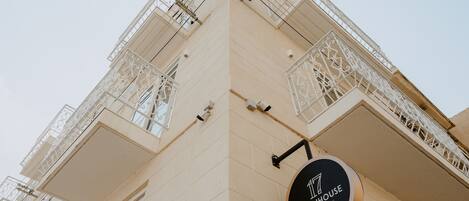 A building with balconies and a sign that reads "TOWNHOUSE".