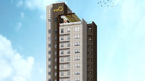 A high-rise hotel with a modern design, featuring a prominent logo at the top and multiple balconies. - Harolds Hotel Quezon City (Quezon City)