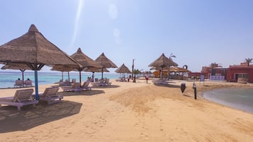 On the beach, sun-loungers, beach umbrellas, beach towels