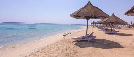 On the beach, sun loungers, beach umbrellas, beach towels