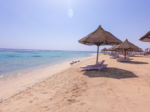 On the beach, sun-loungers, beach umbrellas, beach towels - MG Alexander The Great (Marsa Alam)