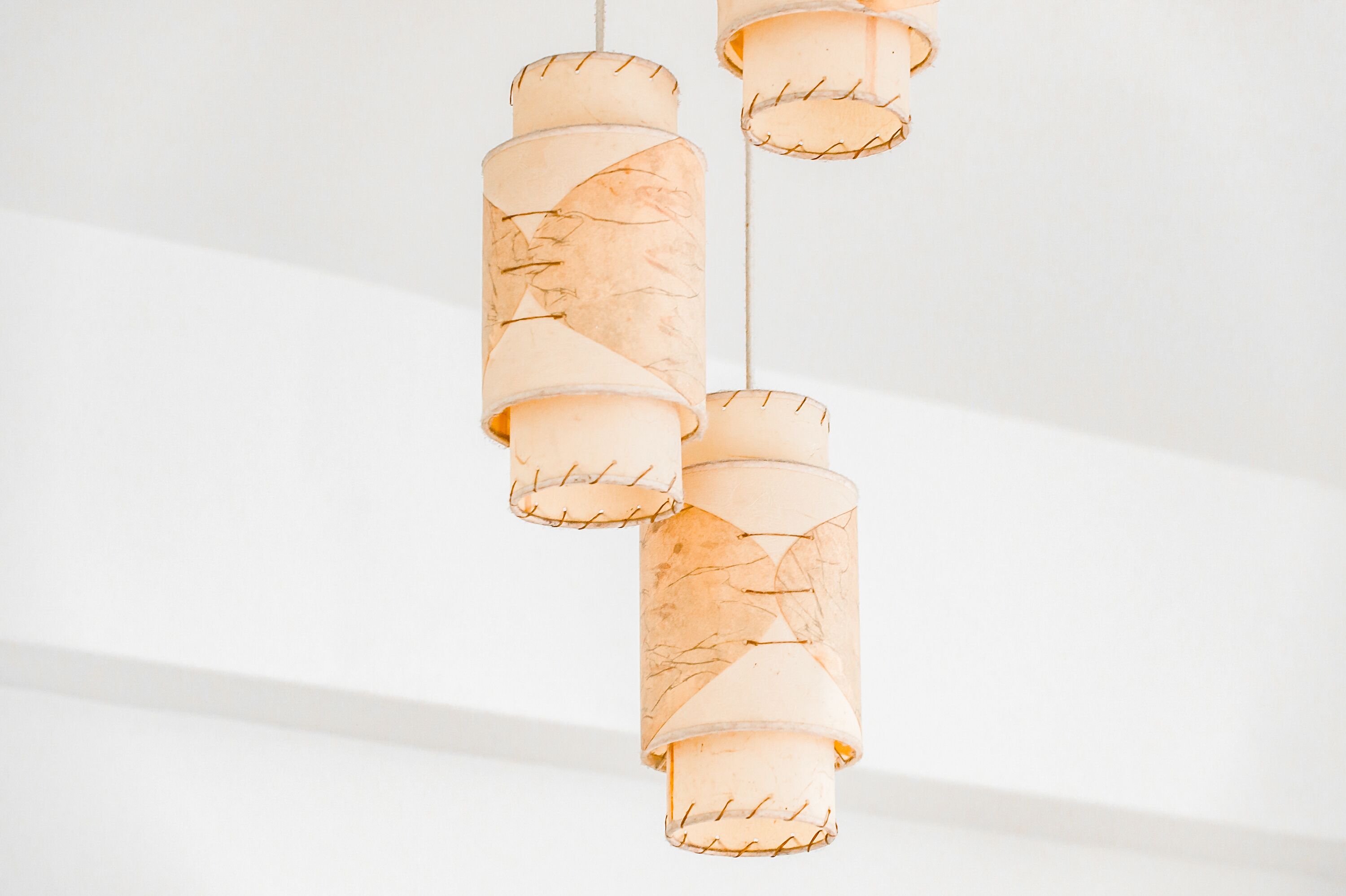 A series of hanging pendant lights with a unique, textured design.