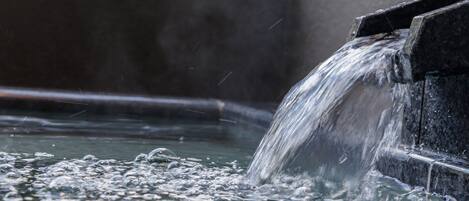 A water feature with a cascading flow into a pool.