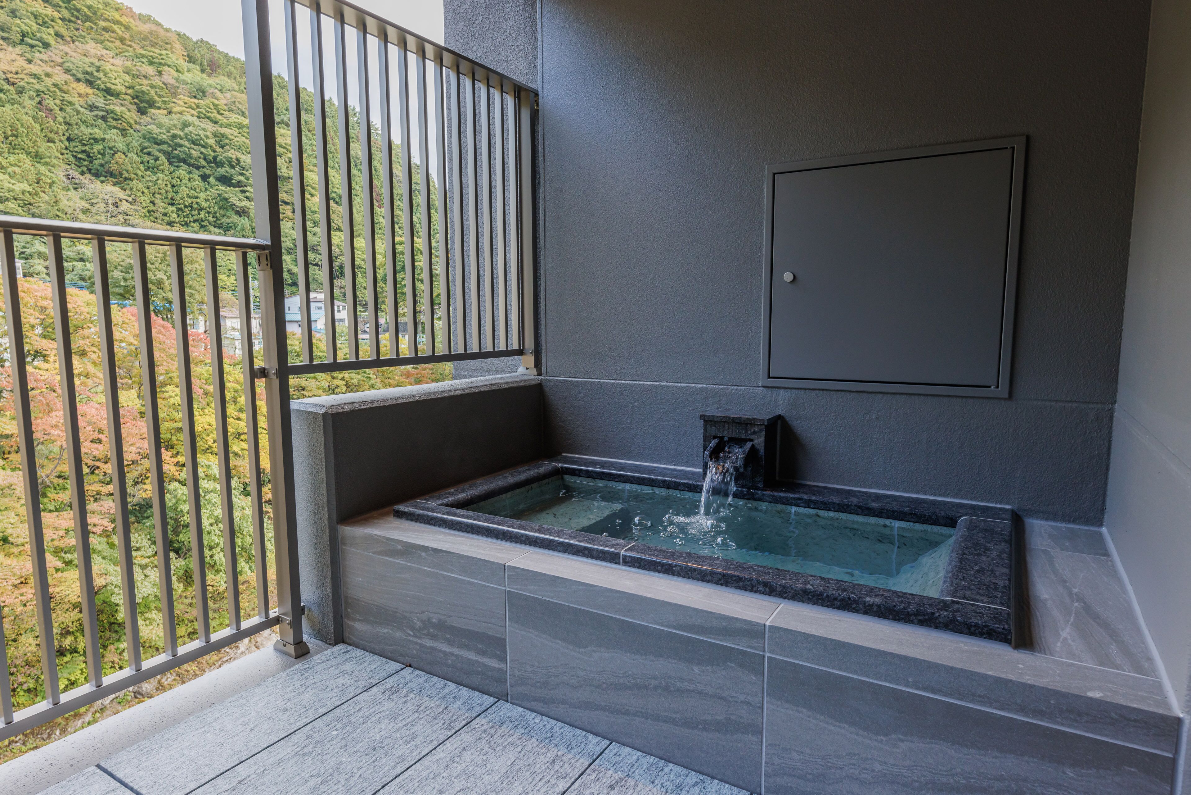 A spa area with a hot tub and a view of a mountainous landscape.