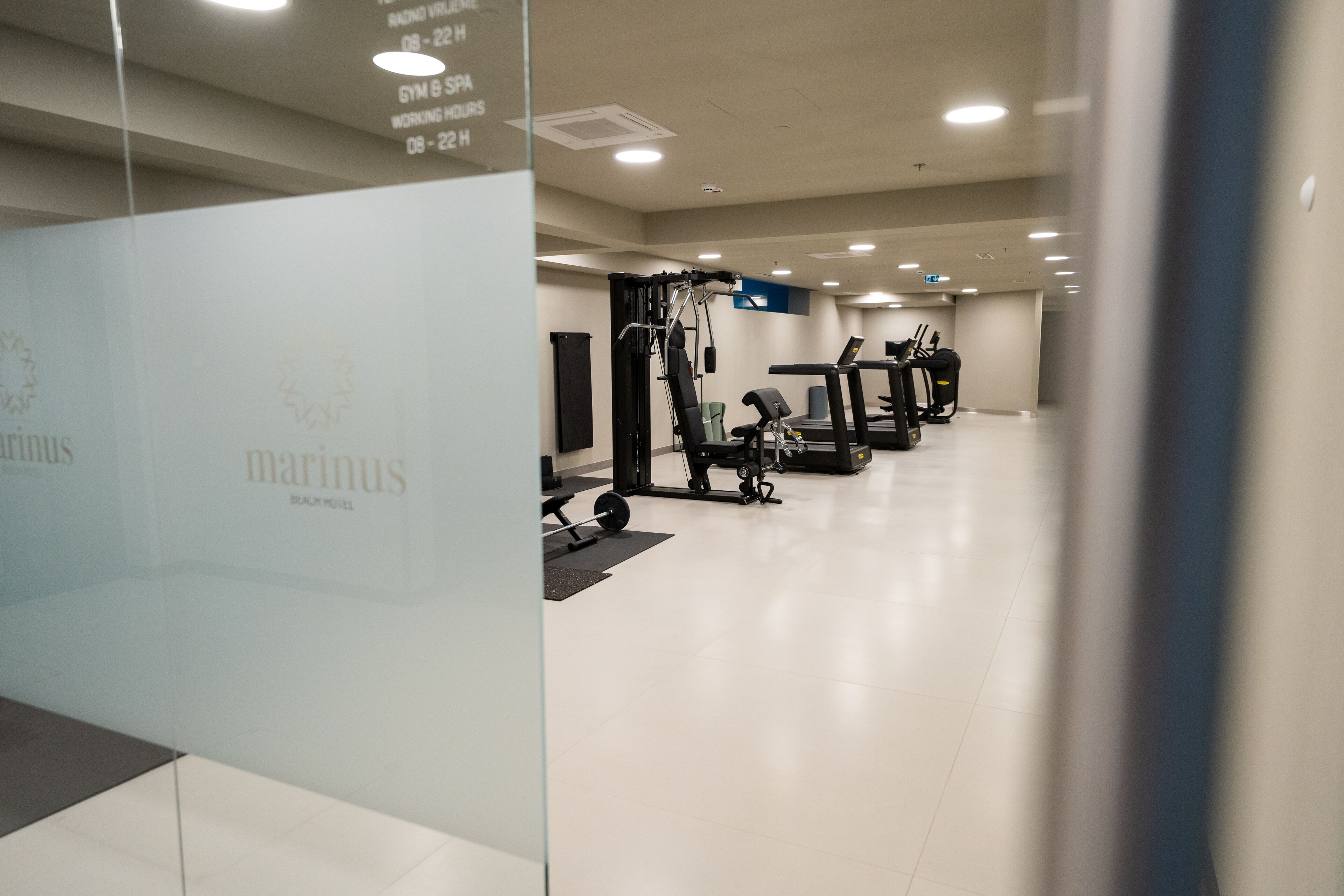 A gym with cardio machines, weightlifting equipment, and a clean, modern design.