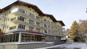 A multi-story hotel with balconies and large windows.